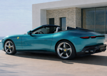 2027 Ferrari Amalfi Spider luxury convertible rear three quarter view parked beside coastal villa overlooking the ocean
