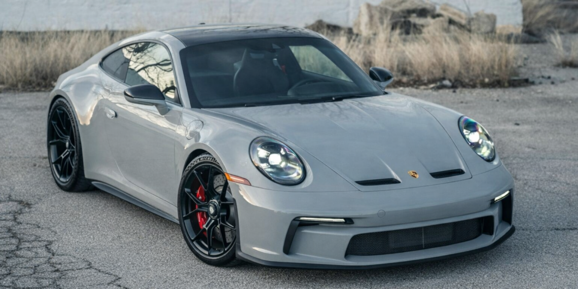 Porsche 911 GT3 in gray parked on urban pavement with black wheels and red brake calipers