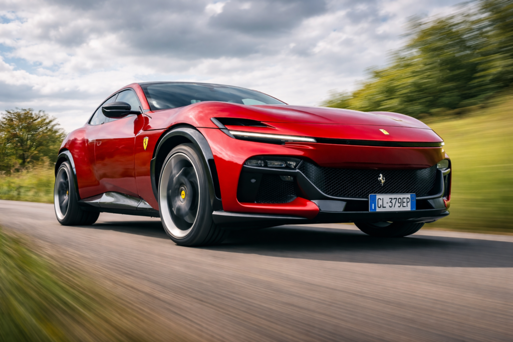 Red Ferrari-inspired performance crossover driving at speed on a country road, captured from a low front angle with motion blur and cloudy skies overhead.