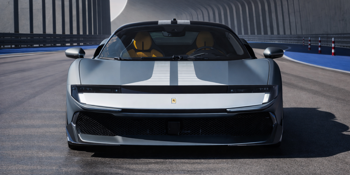 Front view of a silver Ferrari 849 Testarossa on a futuristic test track with dual white racing stripes