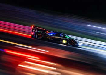 Endurance race car at night with glowing brakes and motion blur pushing beyond redline limits