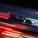 Endurance race car at night with glowing brakes and motion blur pushing beyond redline limits