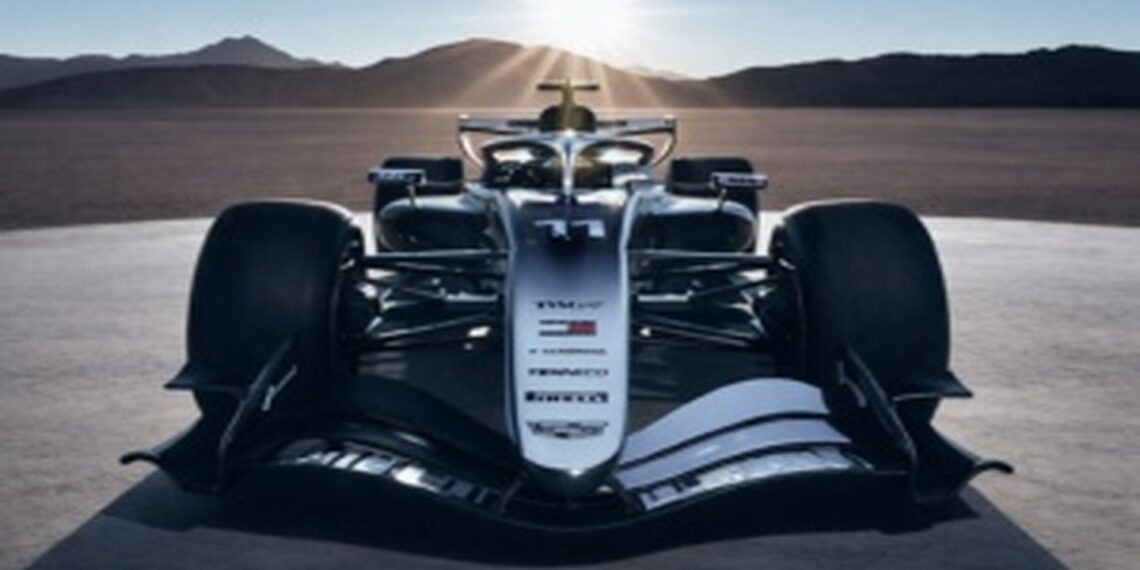Front view of a Cadillac Formula 1 concept race car on a desert flat with mountains and sun rays in the background