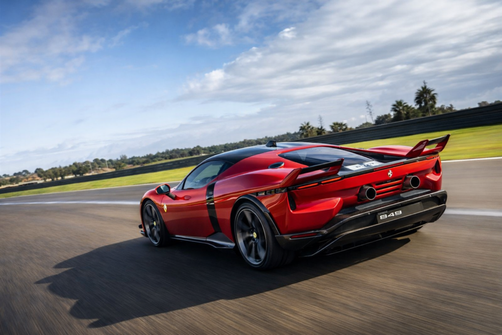 Ferrari 849 Testarossa rear view driving at speed on a racetrack