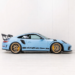 Blue Porsche 911 GT3 RS side profile in a clean studio setting with gold wheels and black aero accents