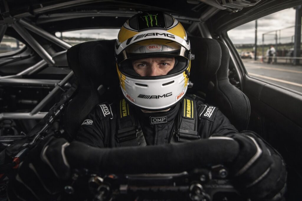 Race driver focused in the cockpit of a modern endurance race car during a realistic track session