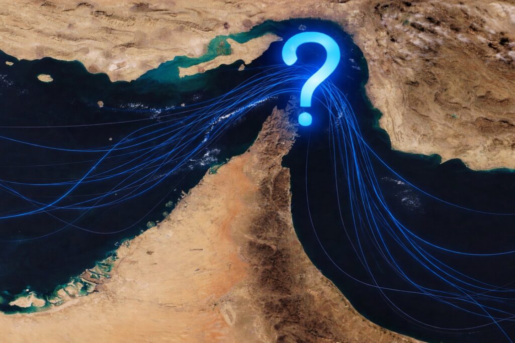 Satellite-style view of the Strait of Hormuz with a glowing blue question mark over the strategic shipping corridor.
