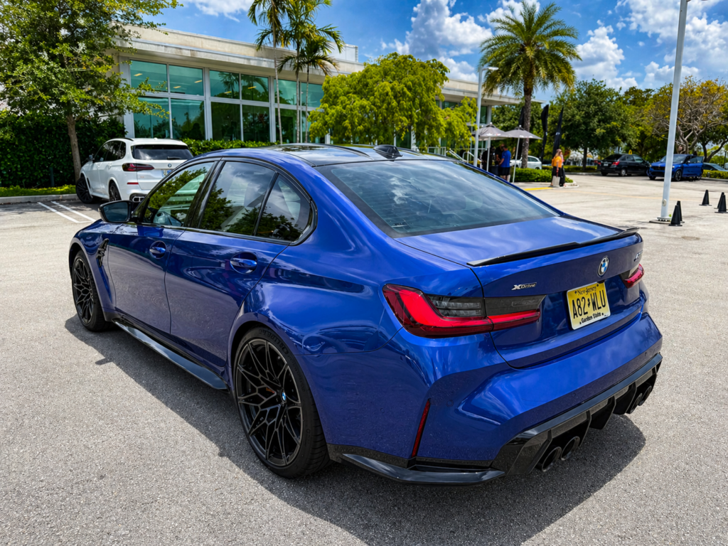 BMW M3 Competition rear three quarter view with quad exhaust