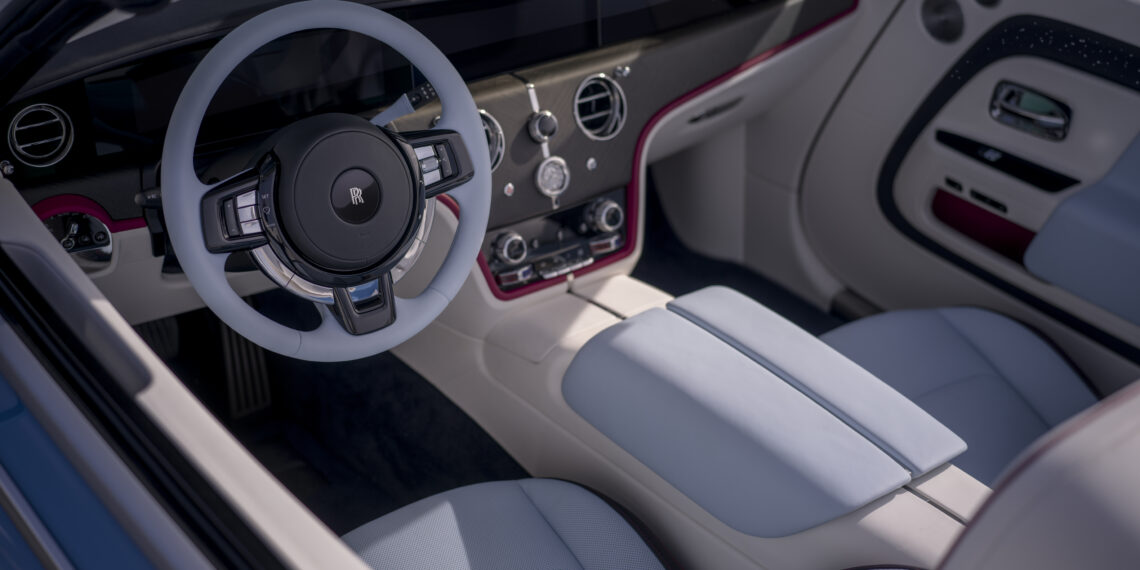 Rolls-Royce luxury interior with white leather seats, red accents, and premium dashboard design