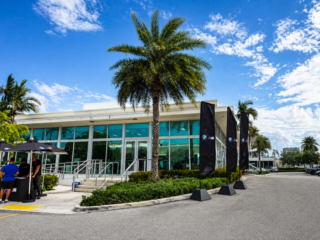 BMW M flags outside dealership during M Town Tour event in Miami