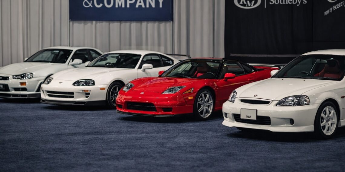 Lineup of iconic JDM legends collector cars including Nissan Skyline GT-R, Toyota Supra, Acura NSX, Mazda RX-7, and Honda Civic Type R at a premium auction display