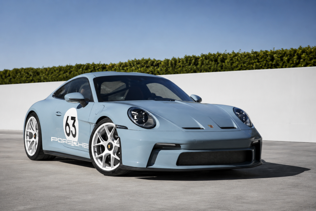 Porsche 911 S/T in light blue finish with heritage graphics in a clean editorial setting
