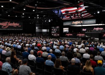 Crowd gathered inside Barrett-Jackson Palm Beach collector car auction arena during live vehicle bidding