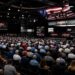 Crowd gathered inside Barrett-Jackson Palm Beach collector car auction arena during live vehicle bidding