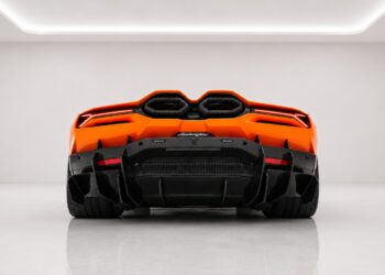 Orange Lamborghini Revuelto rear view with center exhaust outlets and carbon fiber diffuser in a white studio backdrop