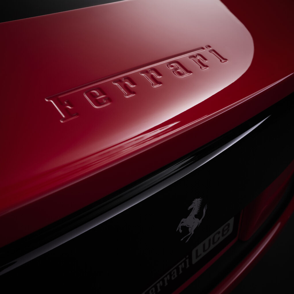 Close-up detail of the embossed Ferrari logo on the Ferrari Luce EV exterior bodywork