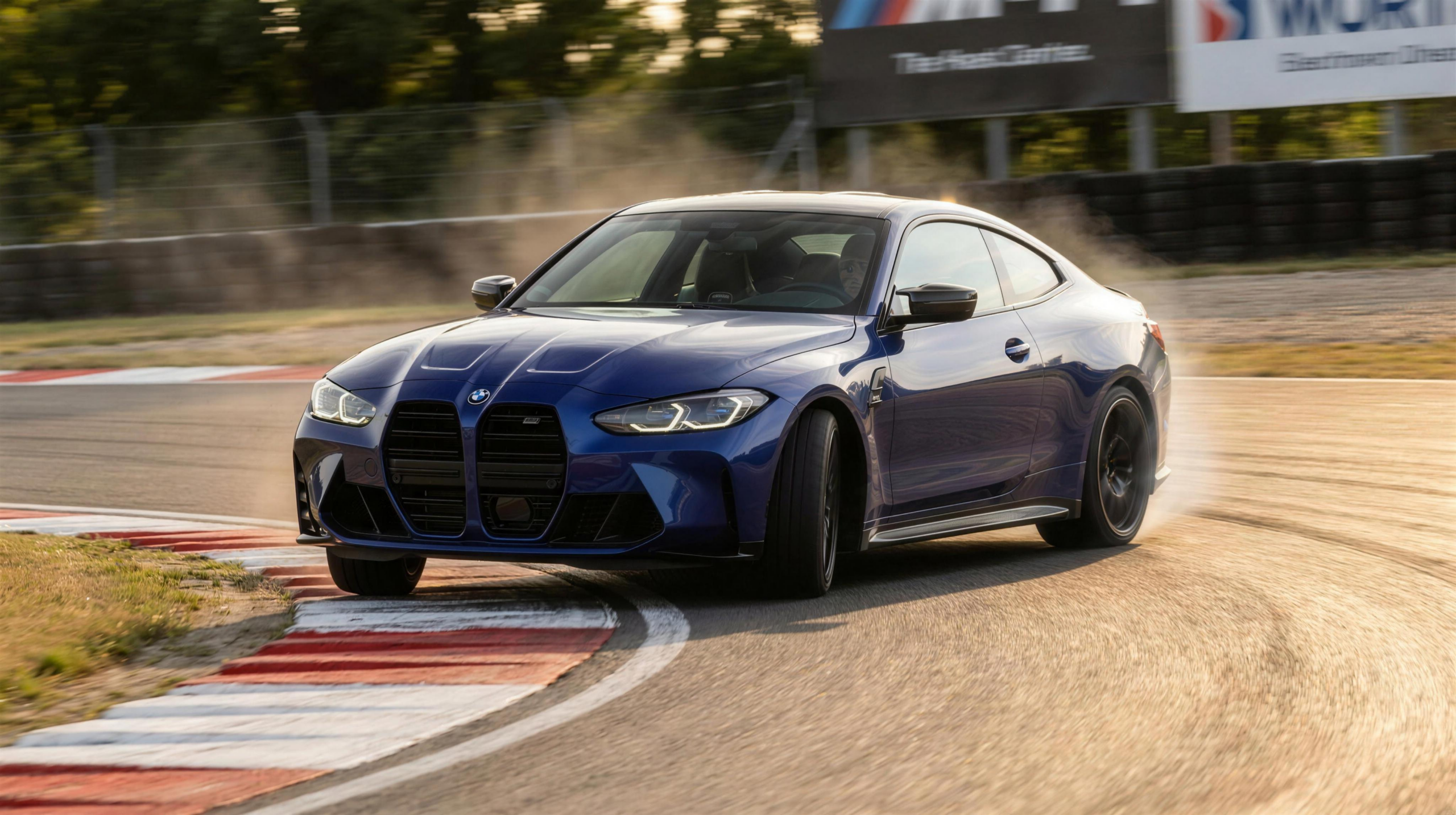 BMW M4 Competition cornering at the apex on a race track