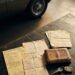 Classic car documentation, service records, ownership papers and keys displayed beside a vintage automobile