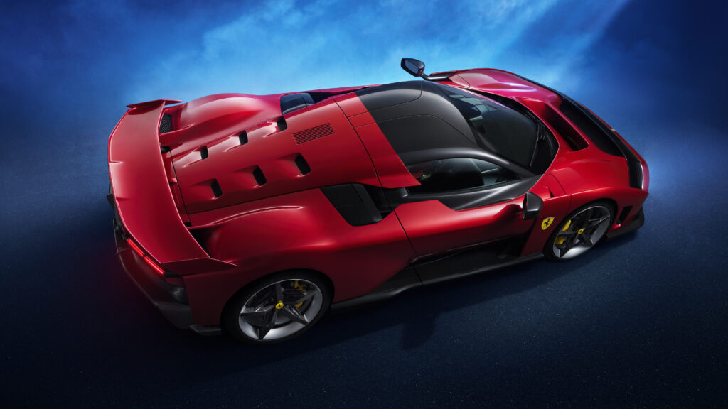 Red Ferrari F80 viewed from above showing its rear wing, aerodynamic bodywork and carbon-fiber cockpit