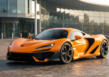 McLaren W1 hypercar in papaya orange outside the McLaren Technology Centre as first customer deliveries begin in summer 2026