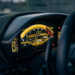 Exotic car digital instrument cluster showing odometer mileage readout