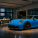 Porsche 911 GT3 992 in exotic dealership showroom next to unsold Aston Martin Vanquish