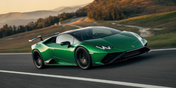 Green V12 hybrid supercar cornering at speed showcasing 48V active anti-roll technology