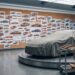 Automotive design studio with a wall of sports car profile sketches and a covered full-size clay model on a turntable