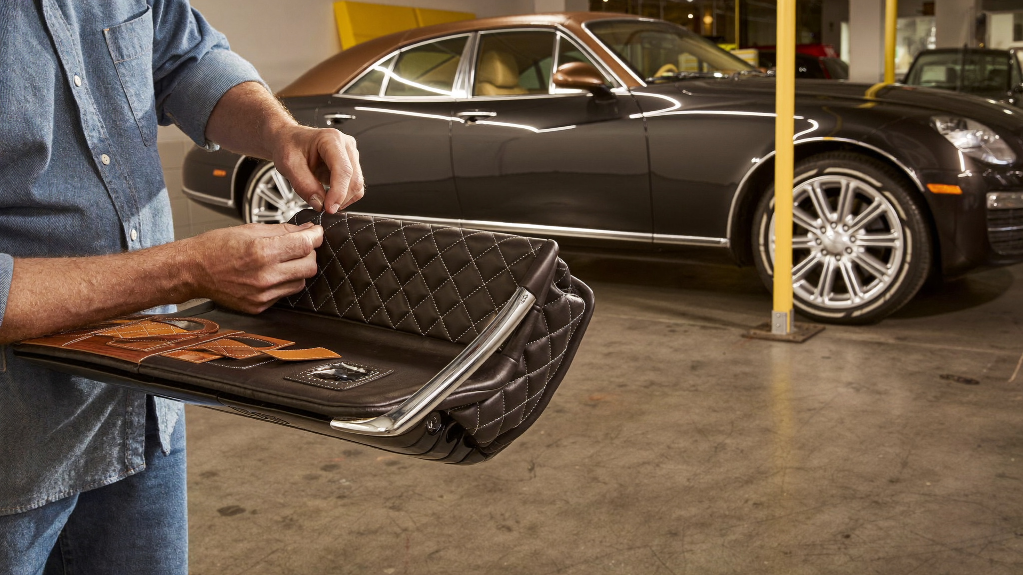 Craftsman hand-stitching quilted leather in an ultra-luxury bespoke automotive atelier, symbolizing the growth of ultra-luxury personalization