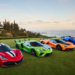 Lineup of exotic supercars at a golden-hour concours event, illustrating the booming 2025-2026 luxury and exotic vehicle marketplace