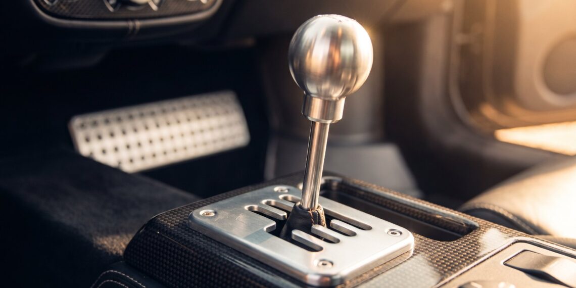 Polished aluminium gated manual shifter in an exposed metal gate on a carbon fibre tunnel, illustrating the Hennessey Blackbird gearbox layout