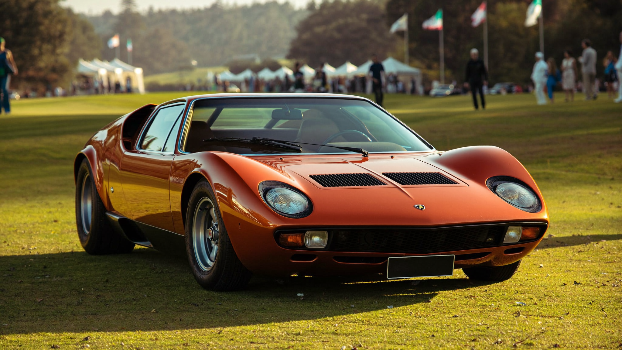 Orange Lamborghini Miura P400 SV front three-quarter view on the fairway at Pebble Beach Concours 2026