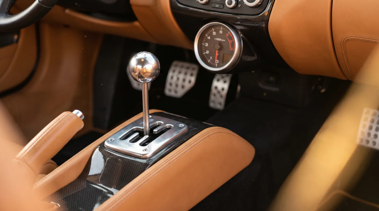 Exposed gated manual shifter and drilled pedals in a naturally aspirated supercar of the type revealed at Monterey Car Week 2026