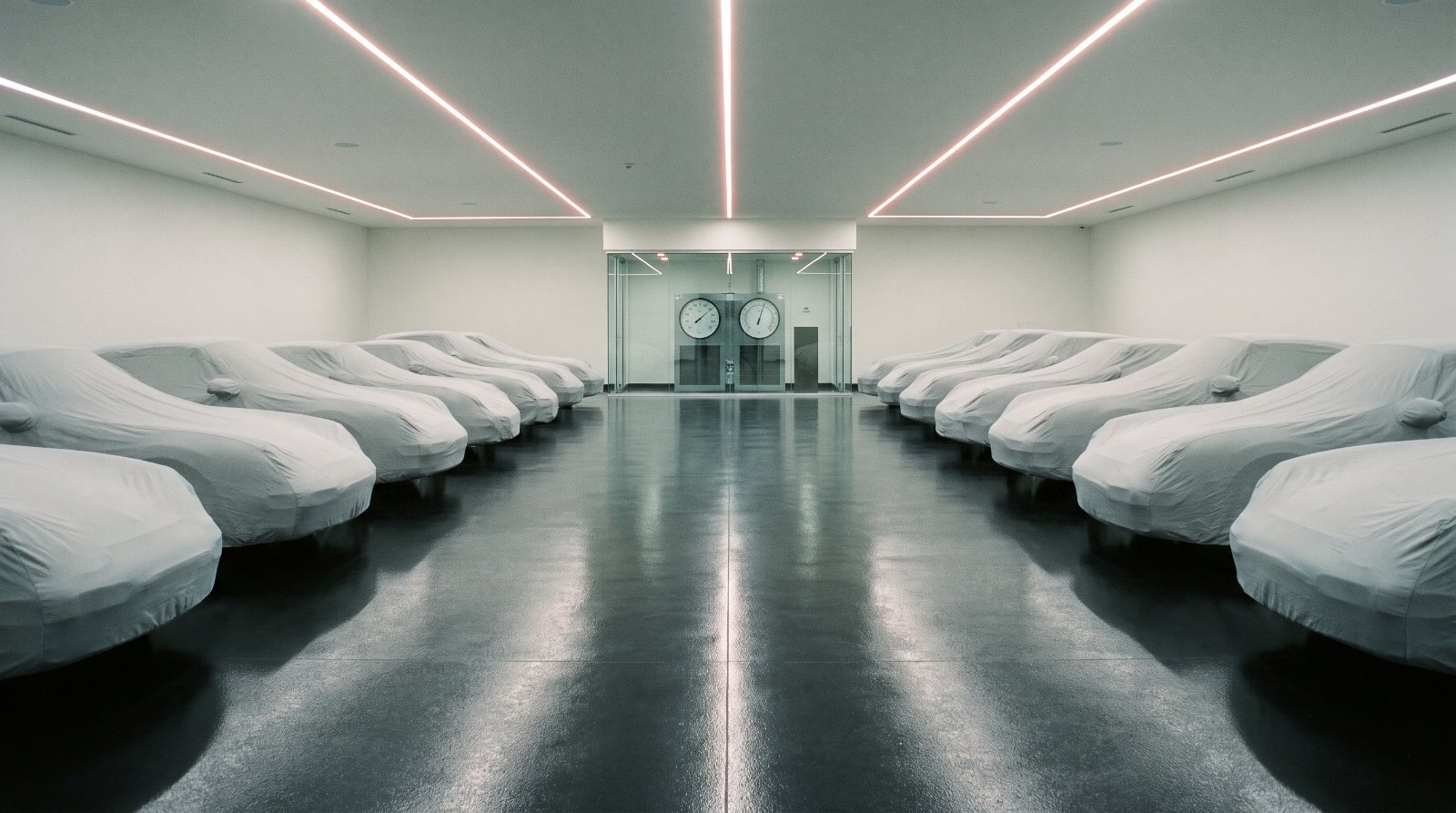 Rows of covered cars in a private climate-controlled collector car storage facility