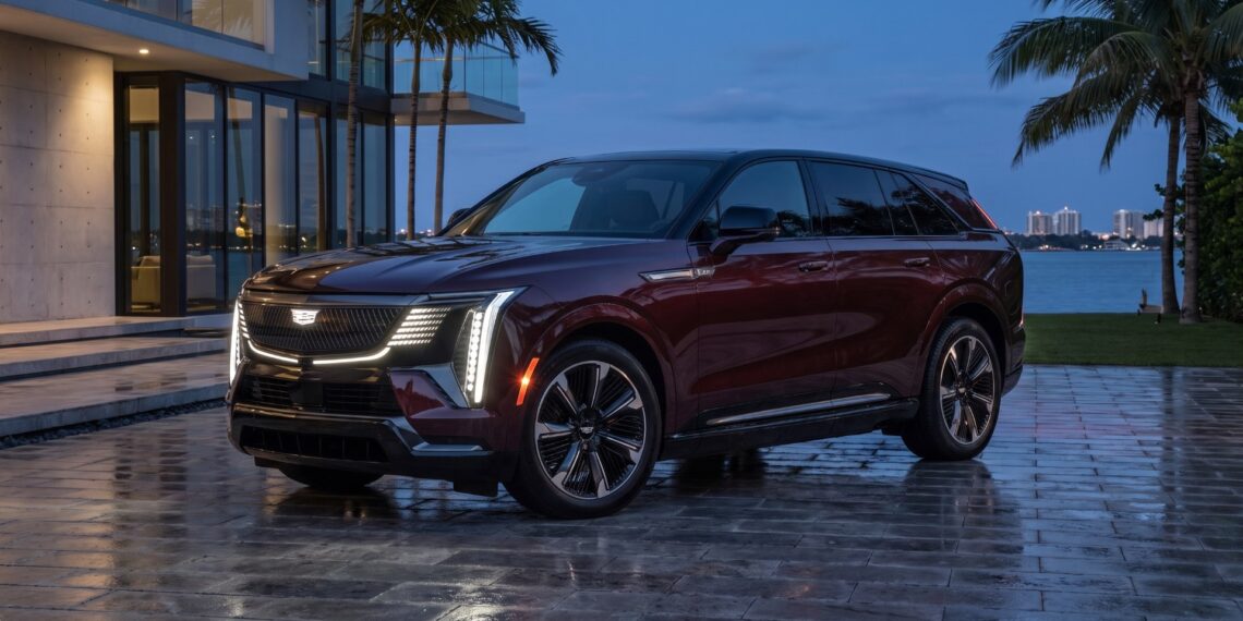 2026 Cadillac ESCALADE IQ front three-quarter view at dusk on a Miami waterfront driveway