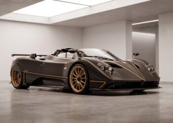 One-of-one supercar in exposed carbon fibre parked inside a supercar atelier before restoration