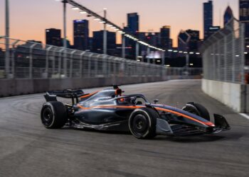 Formula 1-style race car on a city street circuit at dusk as the F1 V8 engine plan for 2030 takes shape