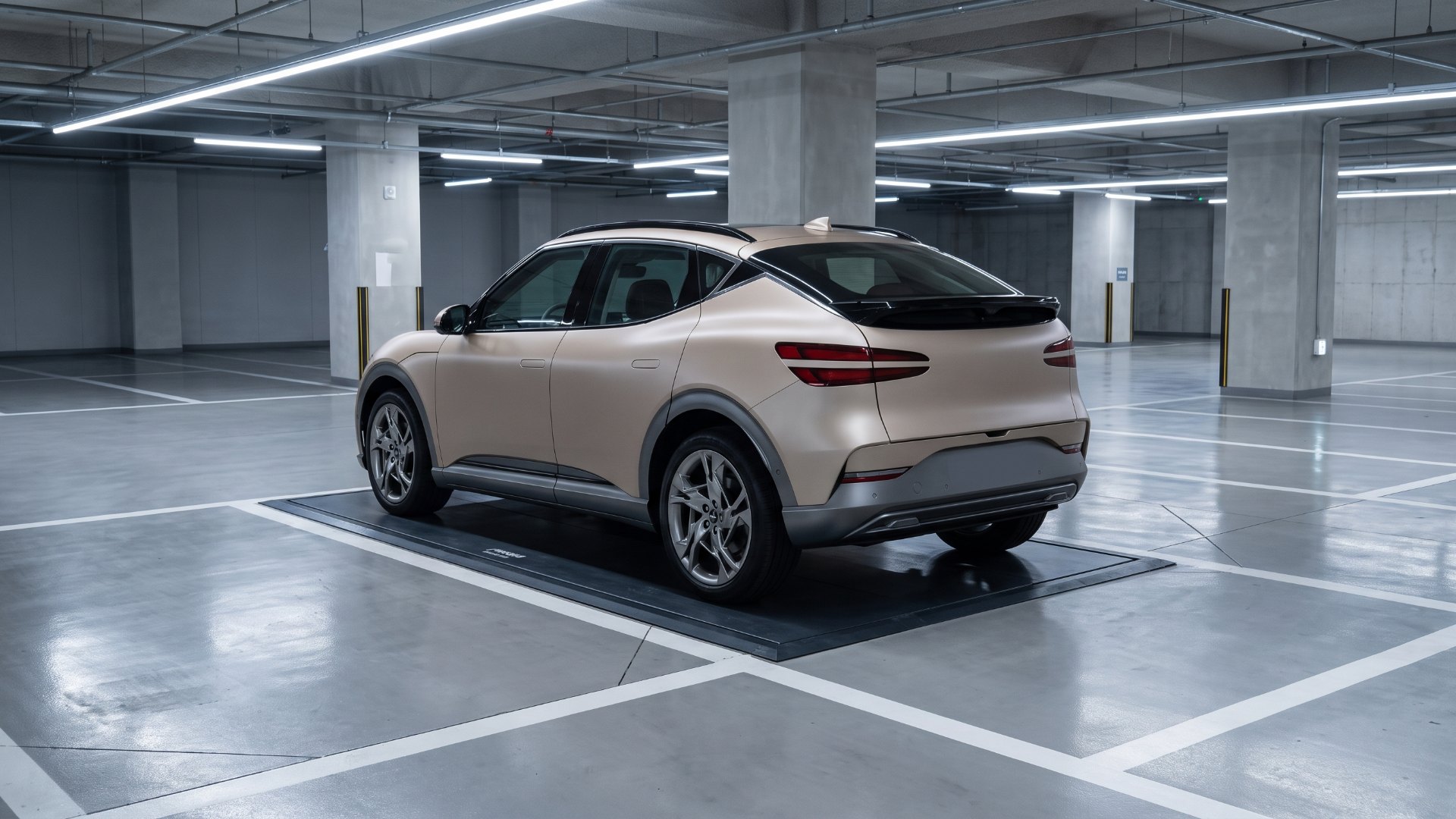 Genesis GV60 parked over a wireless charging pad in an underground parking garage