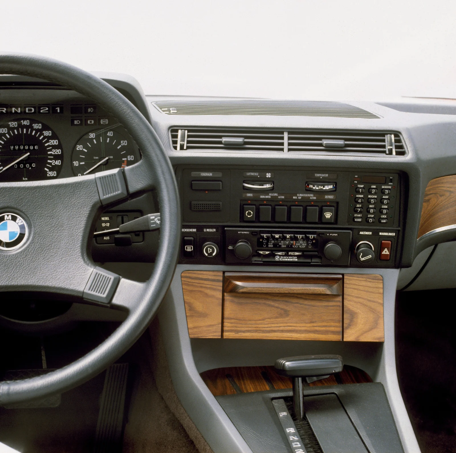 Dashboard of a BMW 745i E23 showing the on-board computer and climate control panel