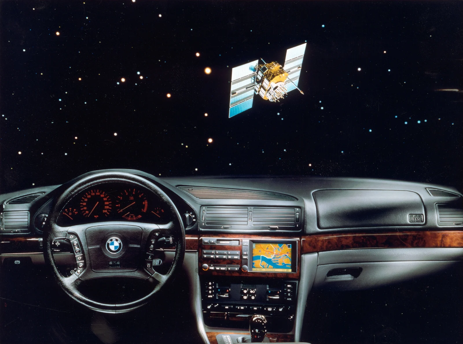 BMW E38 dashboard with a navigation screen, shown in a promotional image with a satellite
