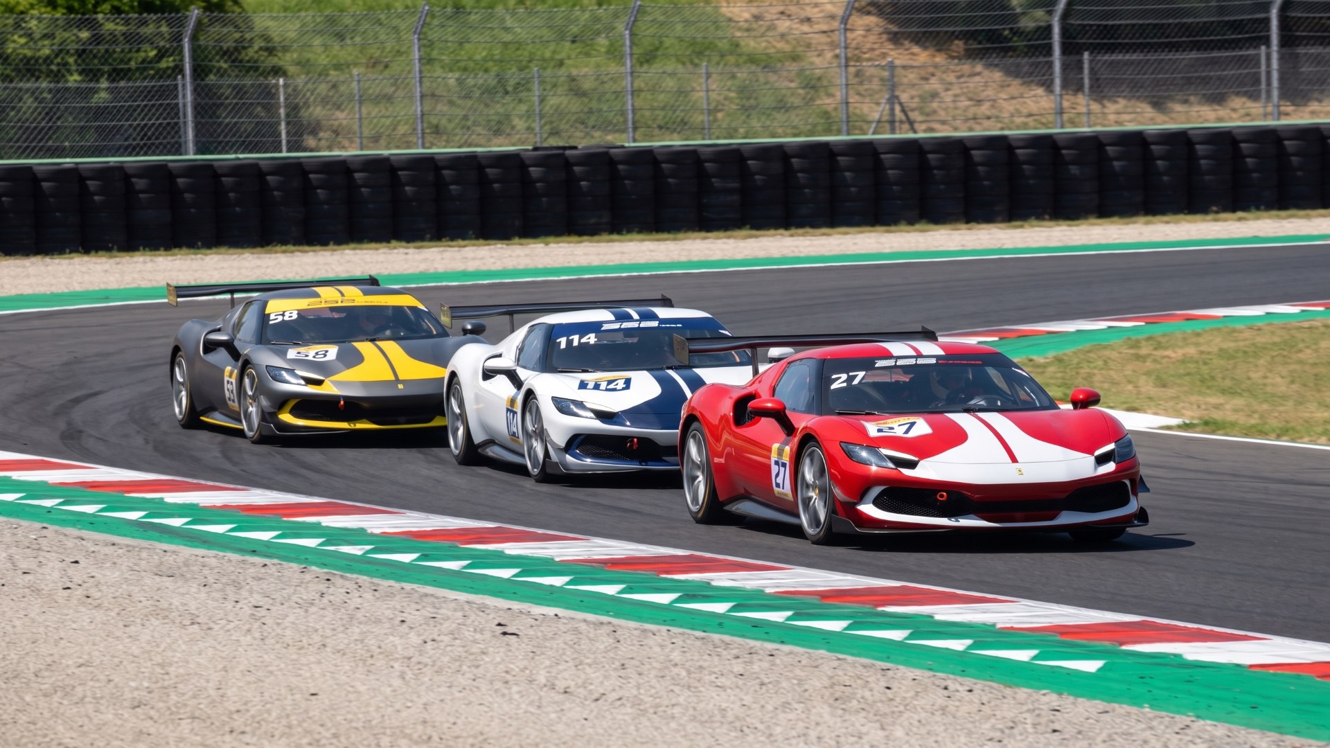 Three Ferrari 296 Challenge race cars run nose to tail through a corner