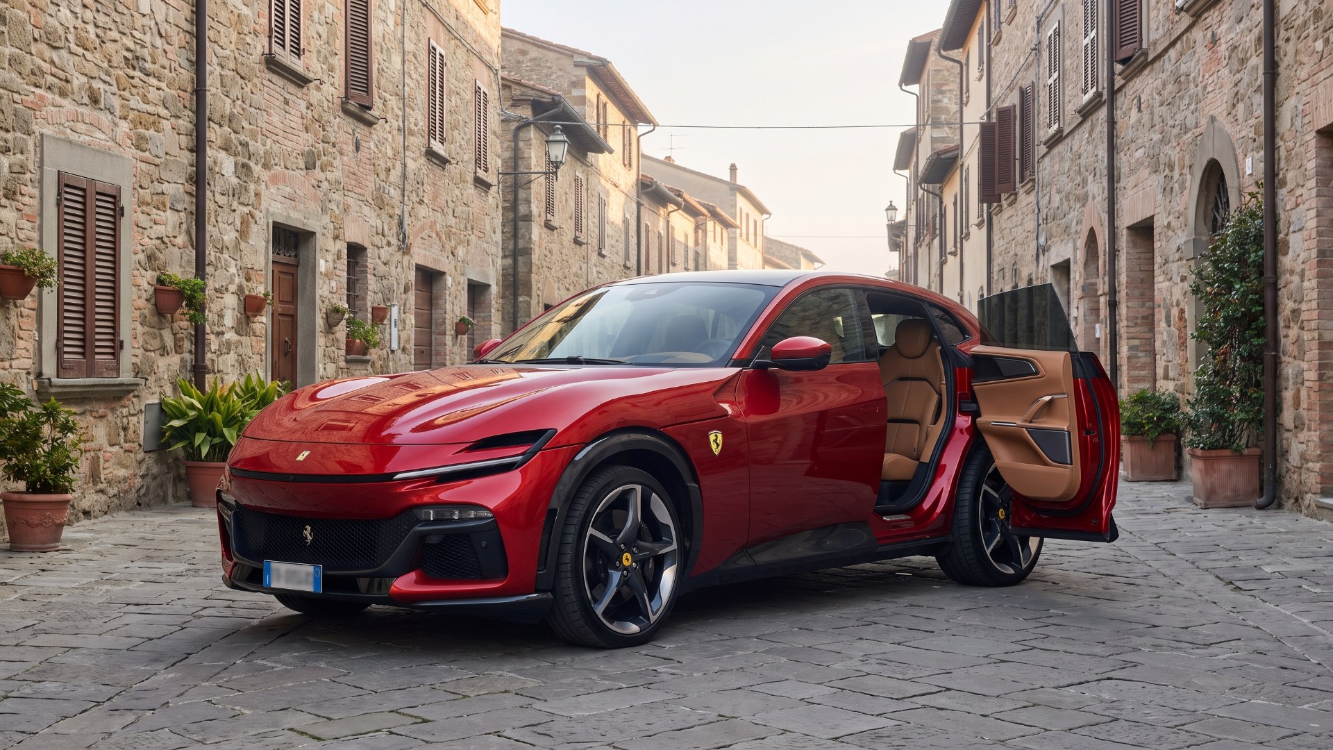 Red Ferrari Purosangue with its rear-hinged rear door open on a cobblestone street