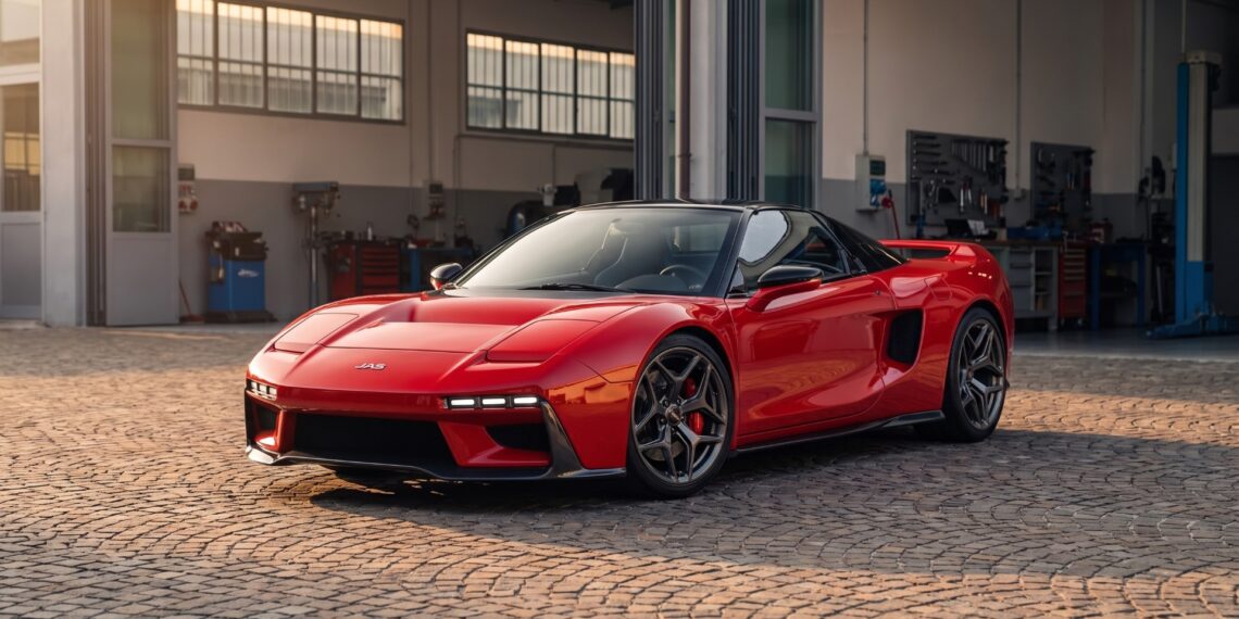 Red JAS Tensei with a black roof and widened carbon bodywork, front three-quarter view in a workshop courtyard