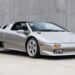 Silver Lamborghini Diablo VT Roadster with its roof panel removed, seen from the front three-quarter
