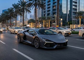 Illustration of a grey Lamborghini Temerario driving along a palm-lined boulevard in Downtown Dubai at dusk, with taxis and glass towers behind it