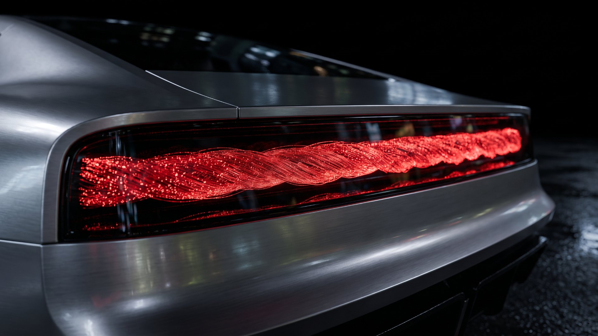 Illustration of twisted red fiber-optic strands glowing across a wide concept-car taillight at night