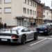 Silver Porsche 911 GT1 Straßenversion road car waiting at a red light on a German town street, editorial illustration