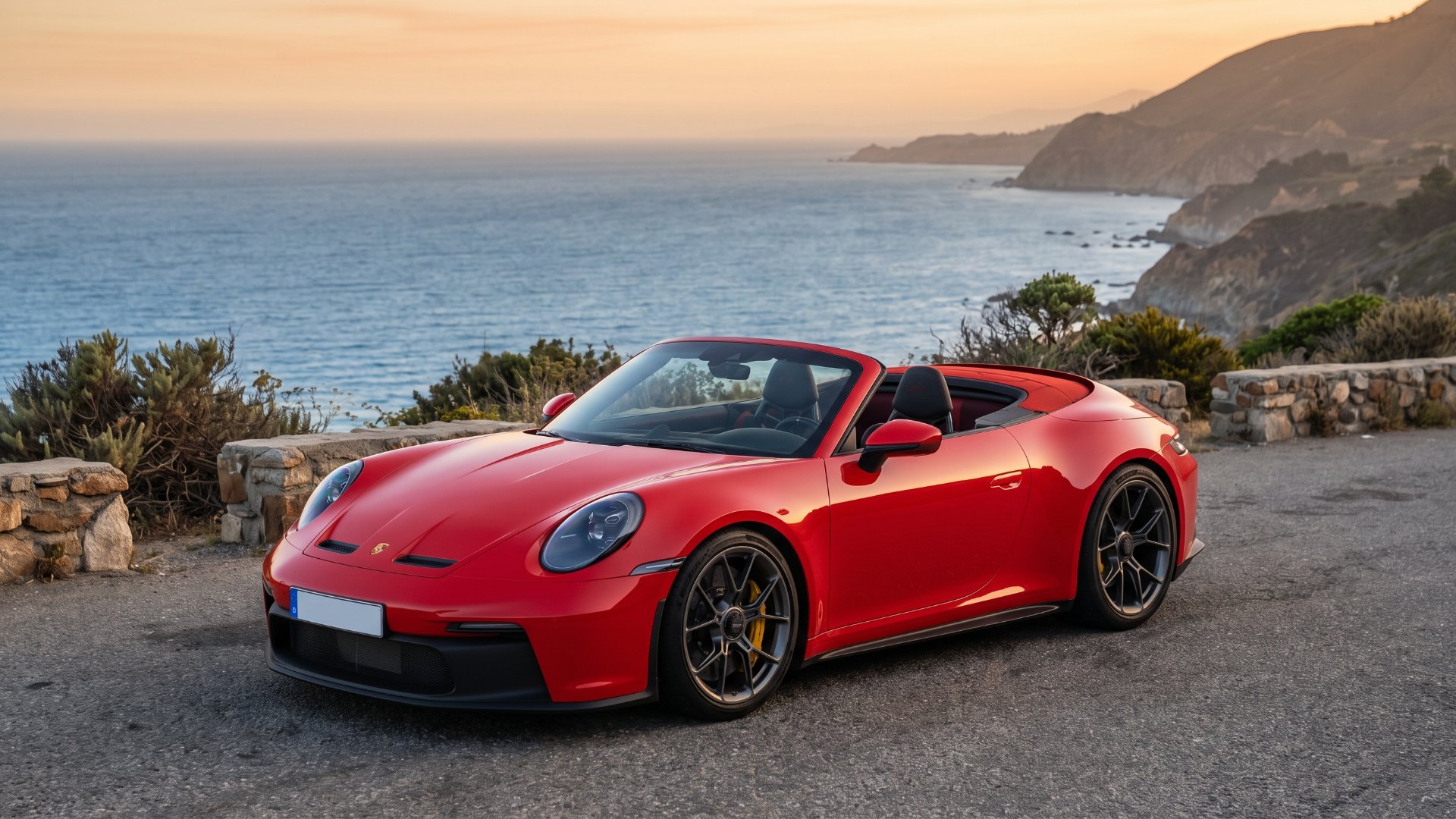 Red open-top Porsche 911 GT3 S/C parked at a coastal overlook