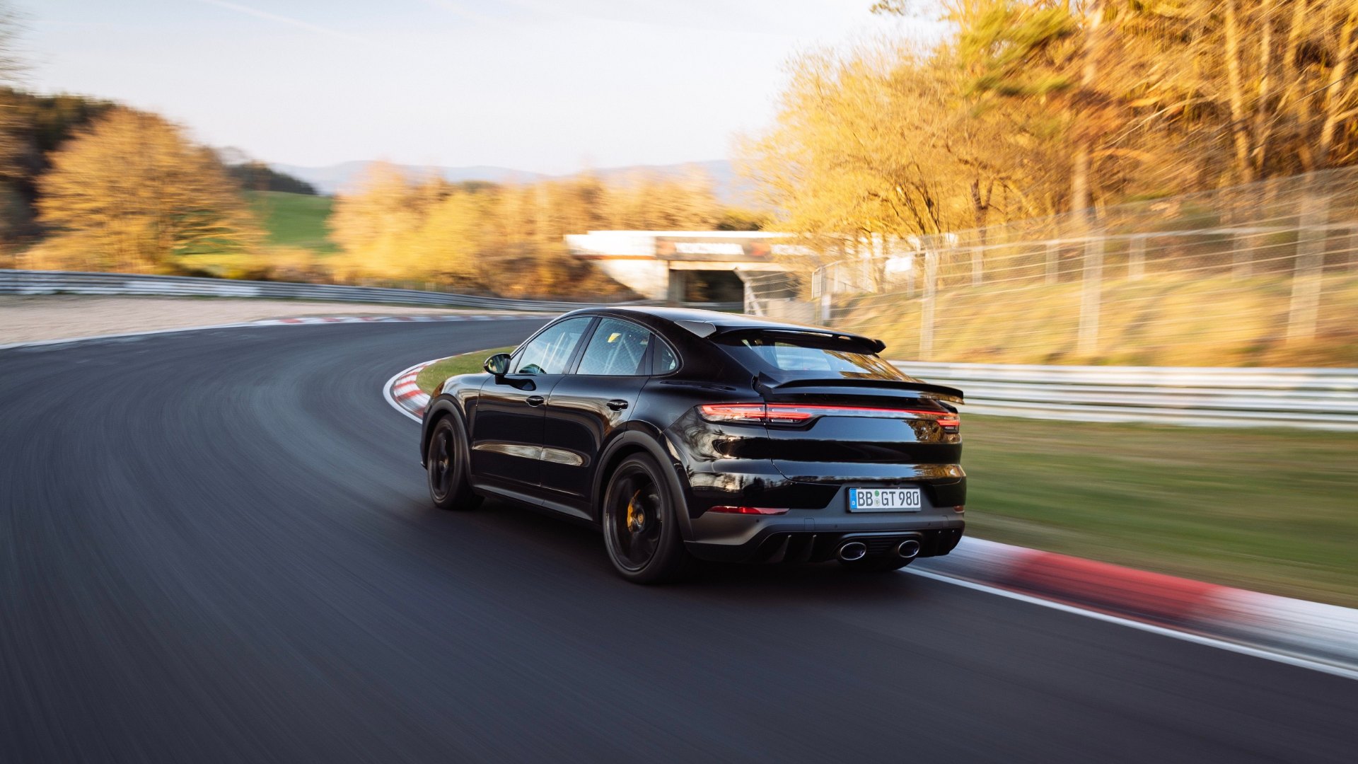 A black Porsche Cayenne prototype cornering on the Nürburgring Nordschleife