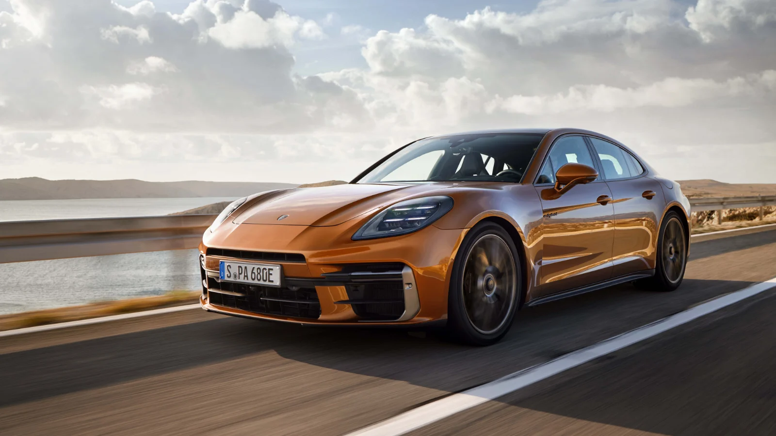 Gold third-generation Porsche Panamera driving on a desert road